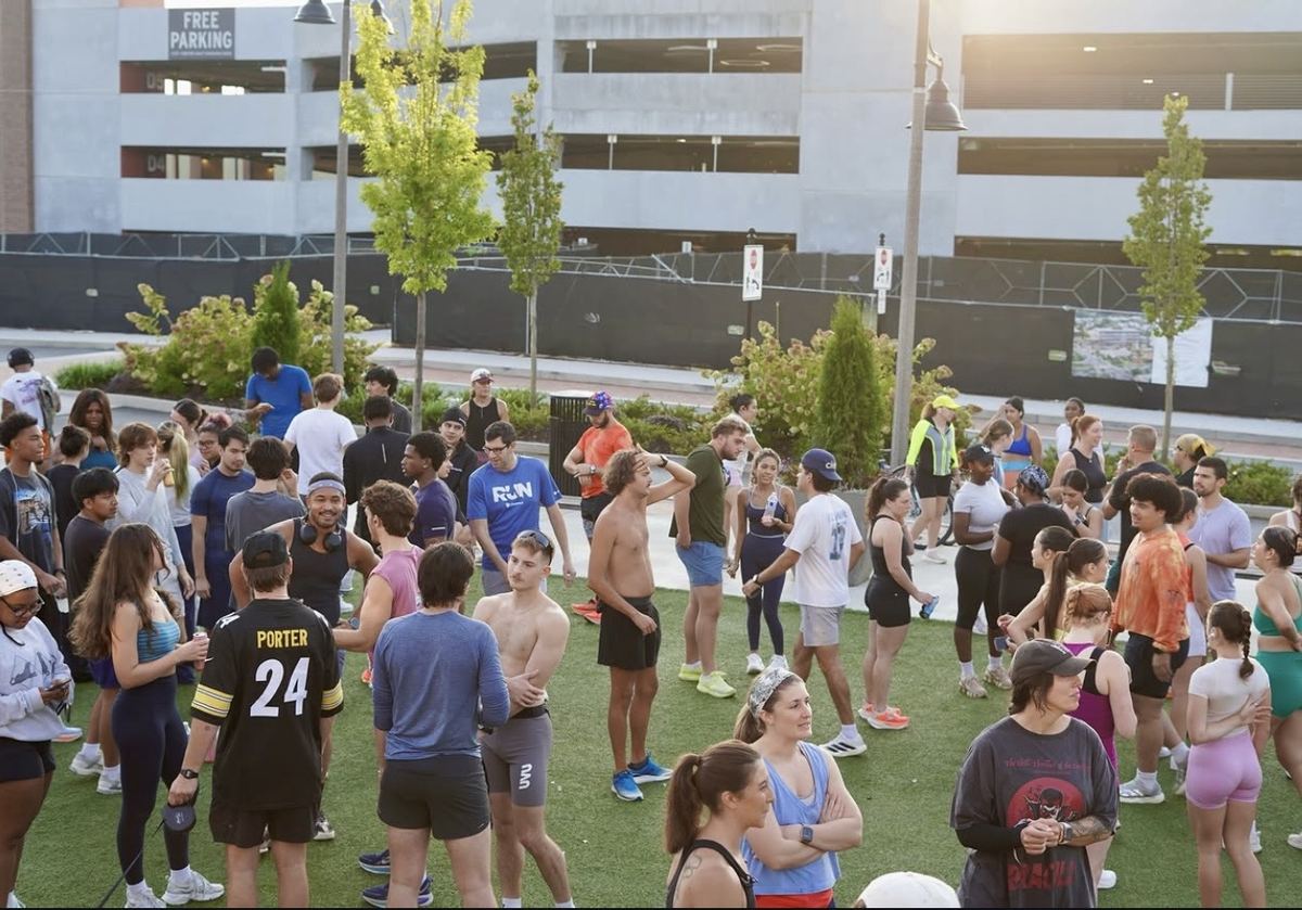 Runners chatting and stretching on the turf before the run